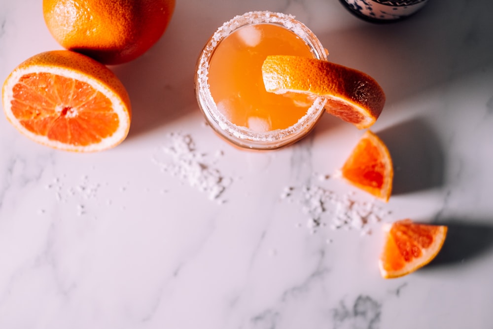 orange fruits on white surface