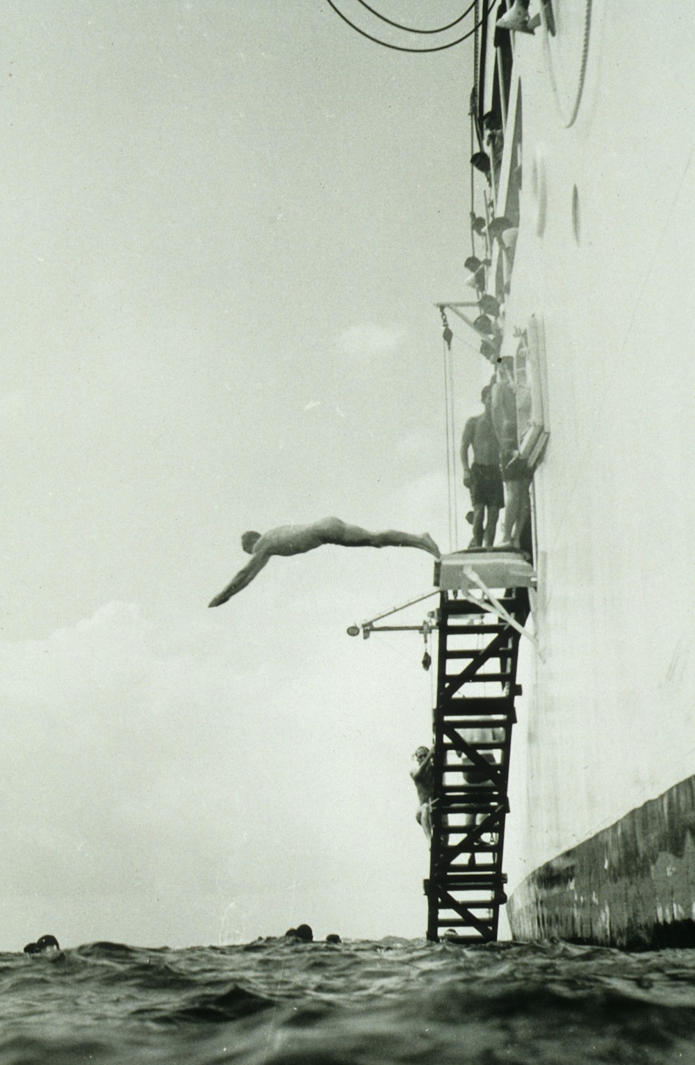 grayscale photography of man diving