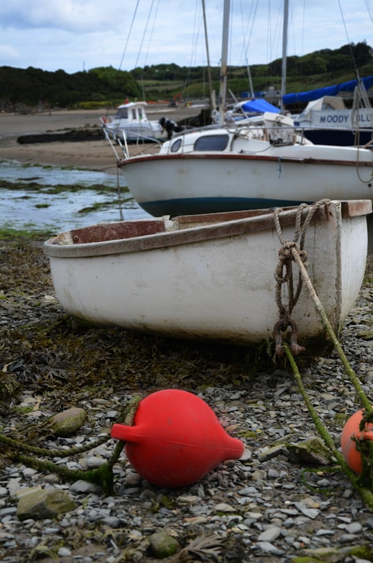 white canoe during daytime in Anglesey United Kingdom