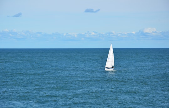 white sailboat in body of water during daytime in Anglesey United Kingdom