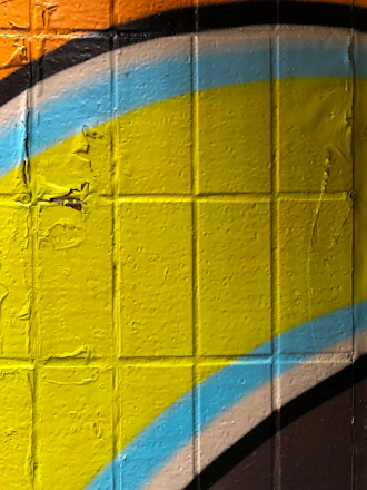 Close-up of a vibrant custom mural being printed on a wall inside a modern living room.