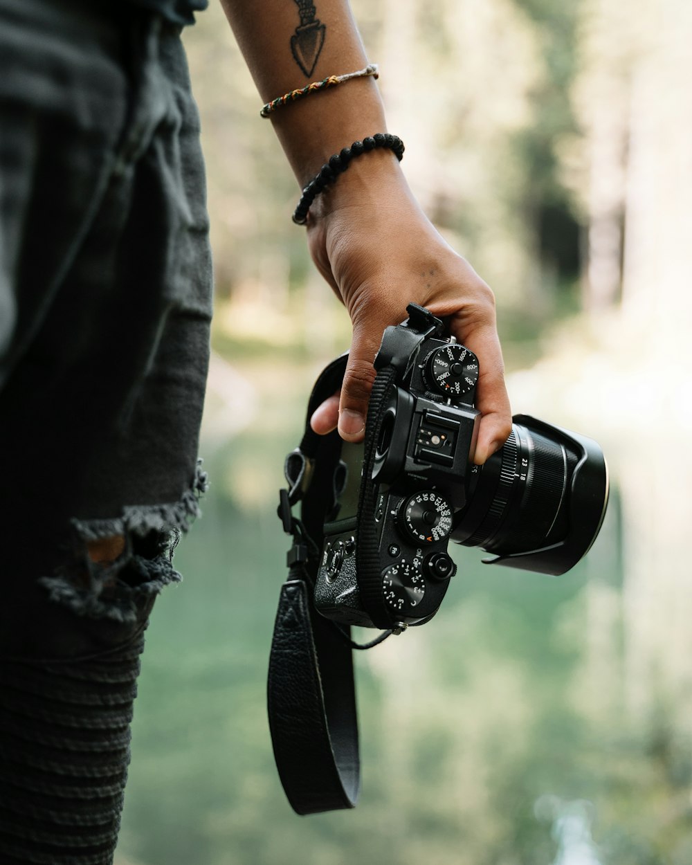 person holding black DSLR camera