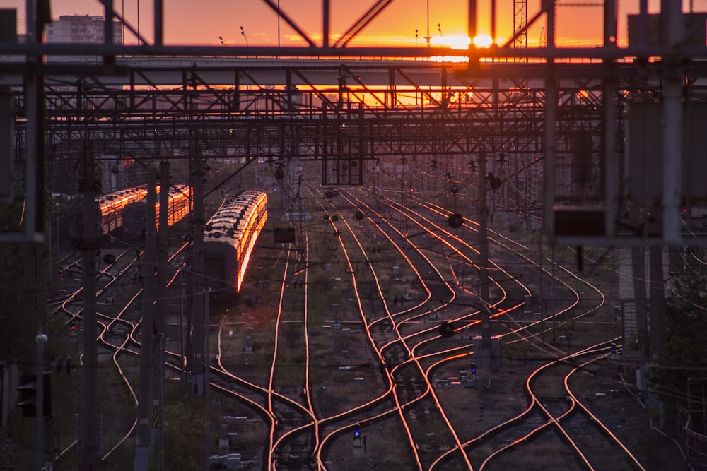 black train on railway during golden hour