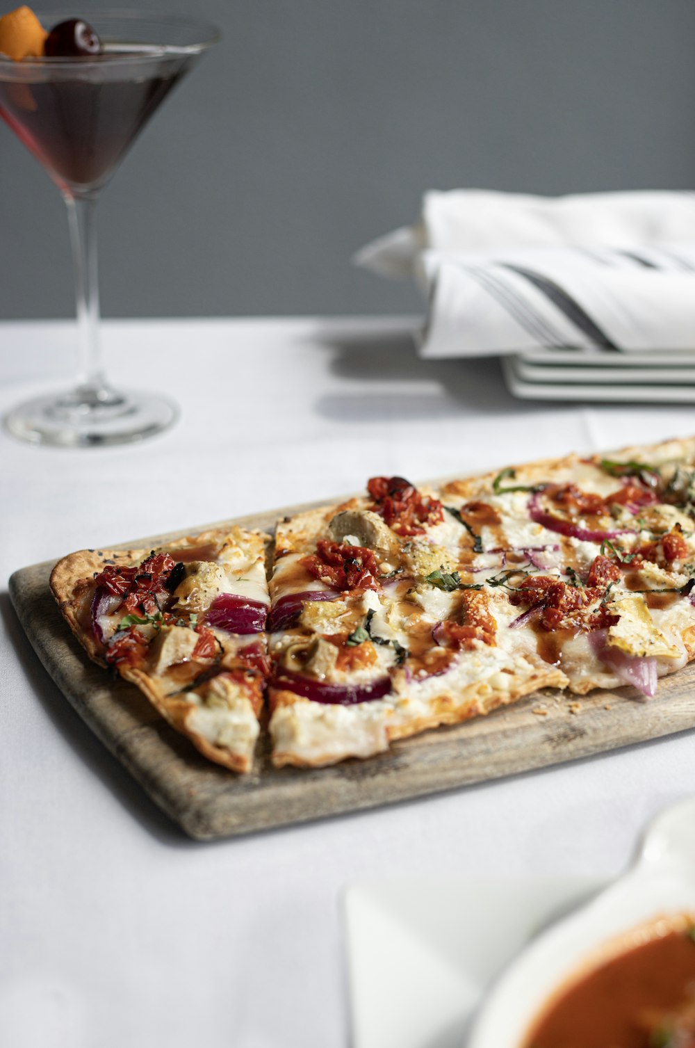 baked pizza on brown wooden platter