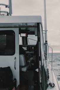 Marine specialist installing navigation equipment inside a boat cabin.