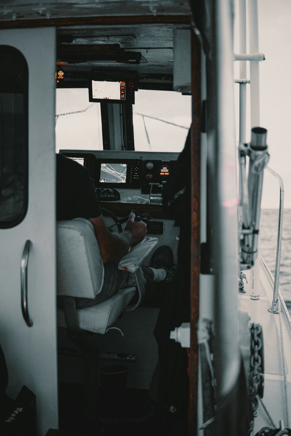 person riding boat steering wheel