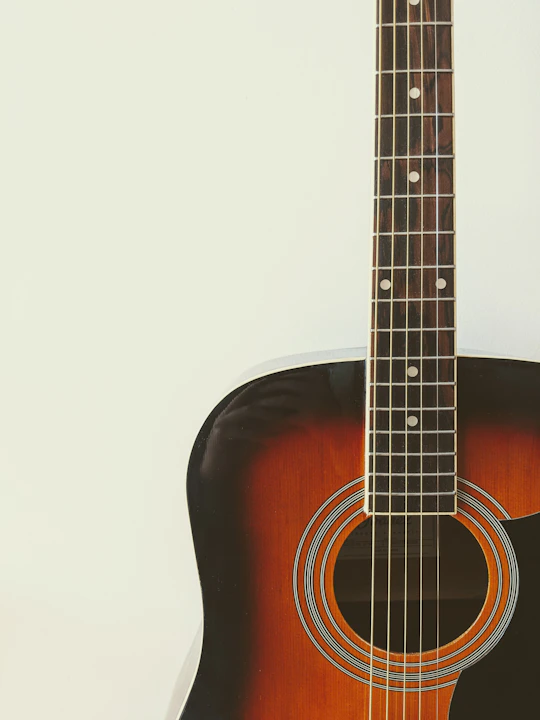 photo of brown and black acoustic guitar