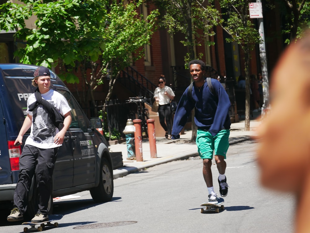 man wearing green shorts riding skateboard