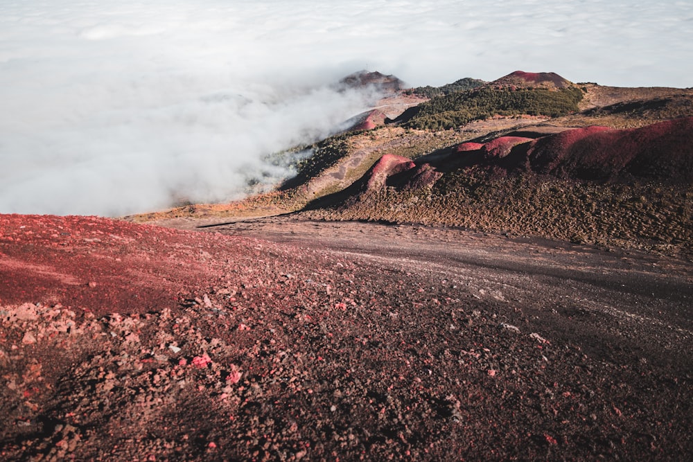 a view of the top of a mountain covered in clouds