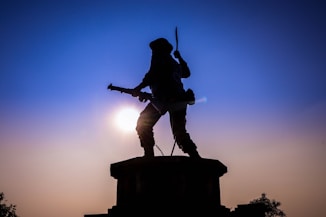 man holding rifle statue