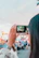 Man attending a lively local festival, capturing moments with his camera.