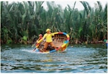 two men riding on boat near trees