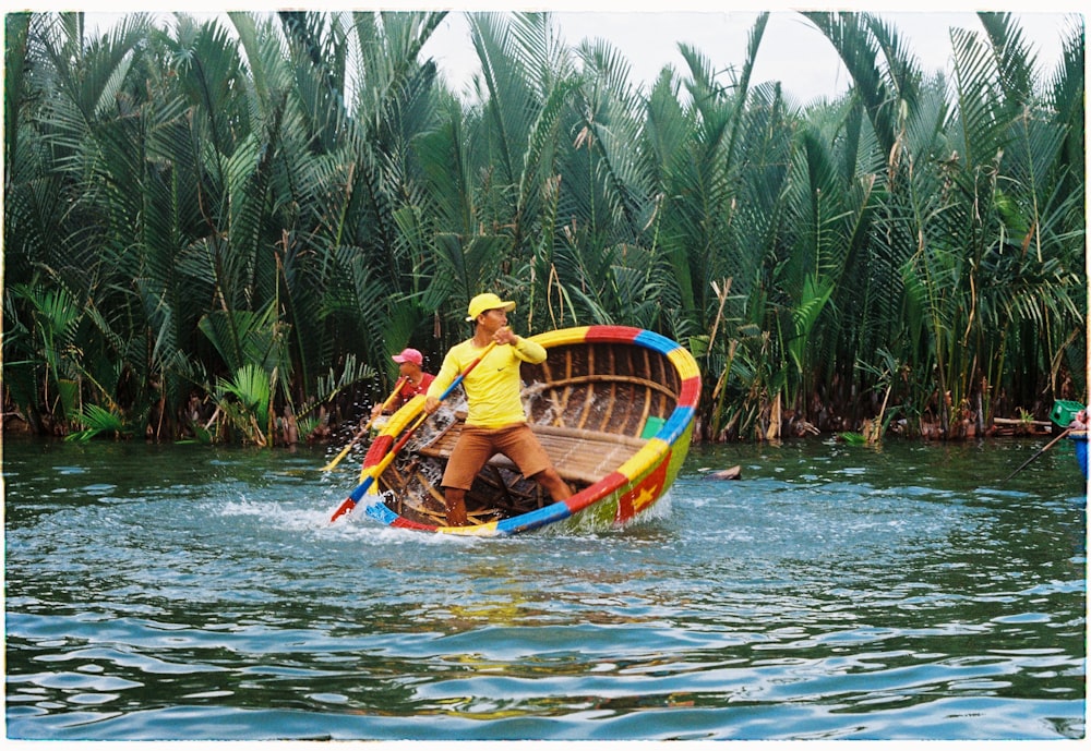 two men riding on boat near trees