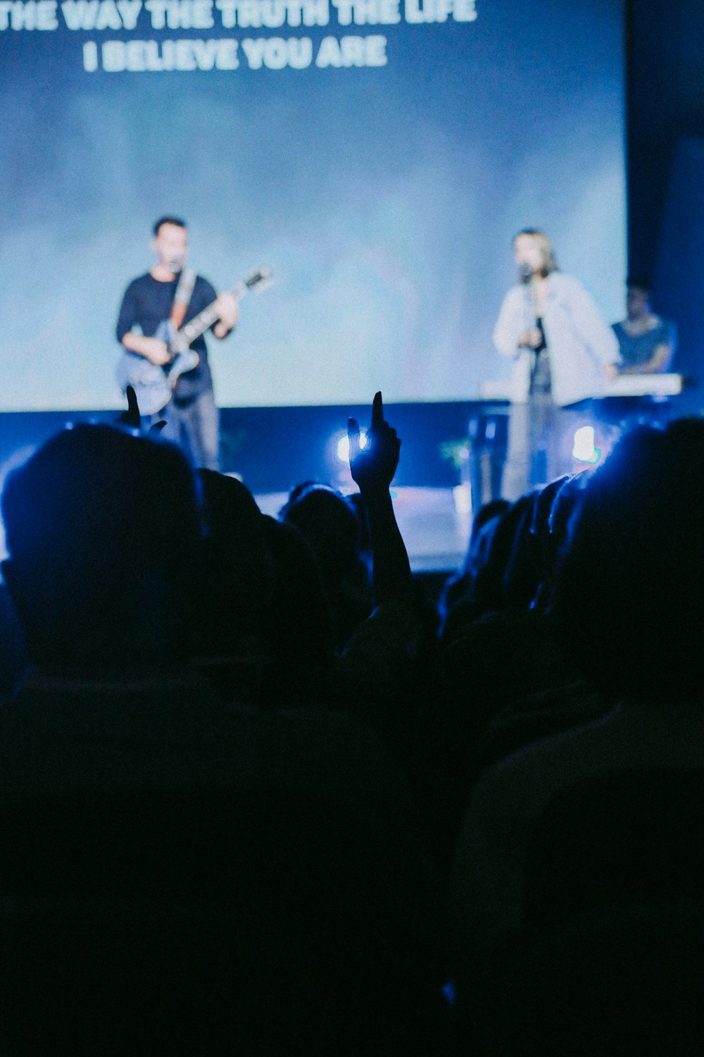 two people singing in stage