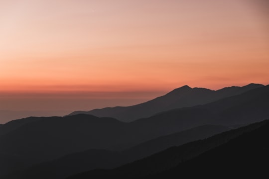 silhouette mountain under orange sky in Pirin National Park Bulgaria
