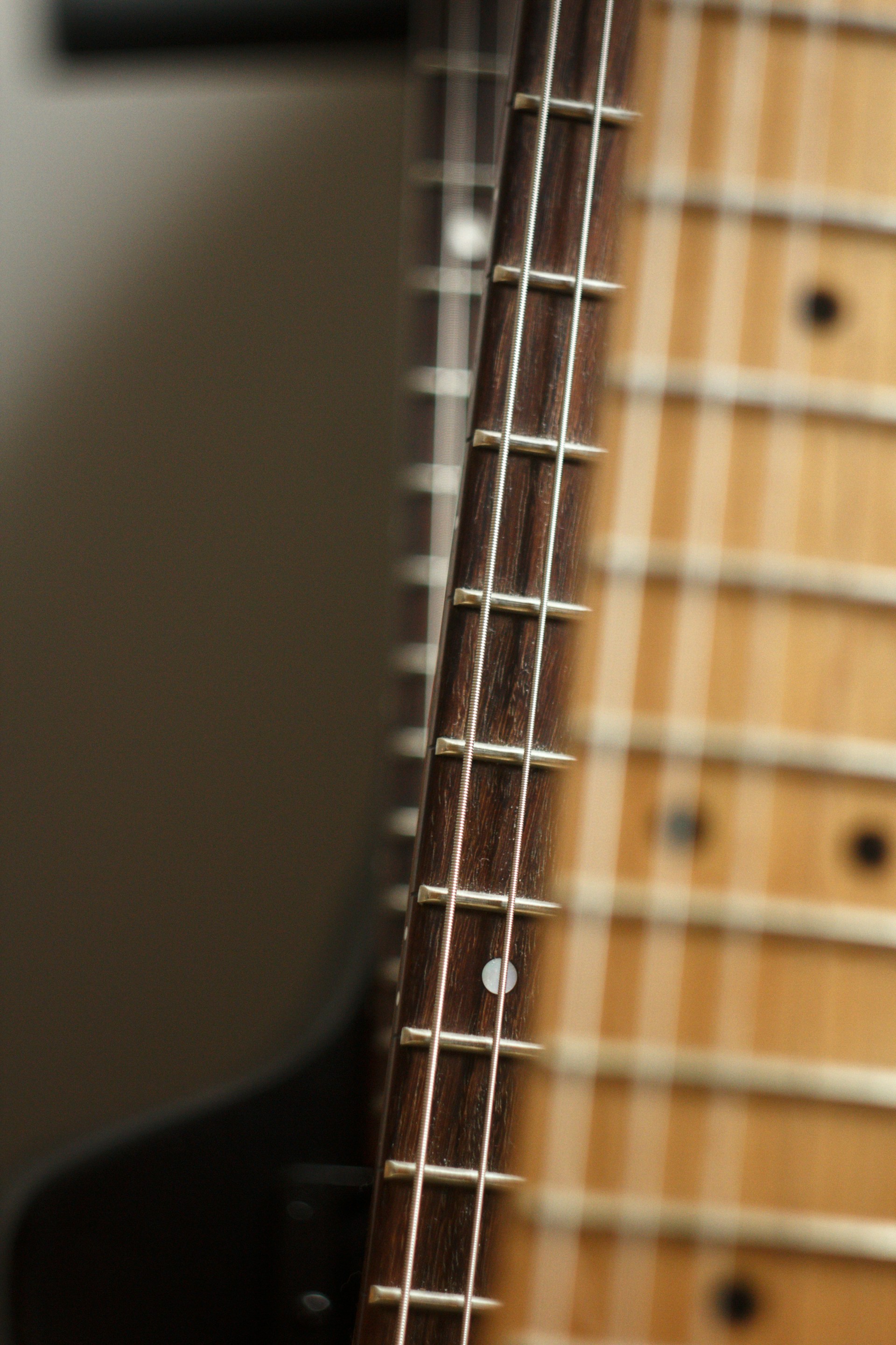 a close up of a guitar neck and strings