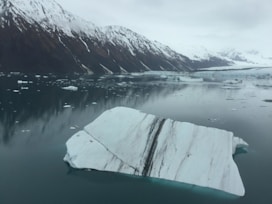 snow rock on body of water