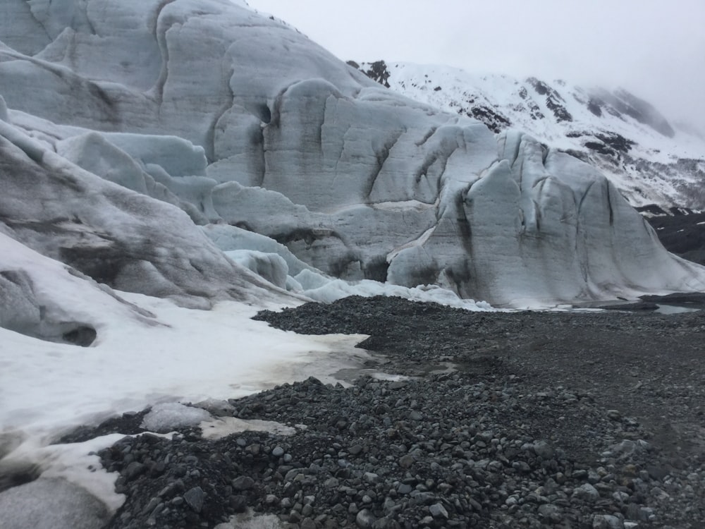 a large glacier with a mountain in the background