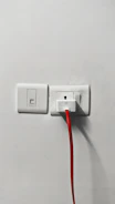 A family unplugging devices from an outlet to prevent overload.