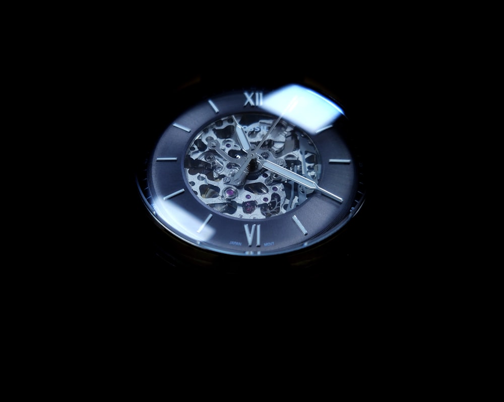 round gray skeleton watch