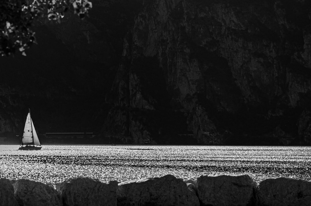 greyscale photo of sailboat on body of water