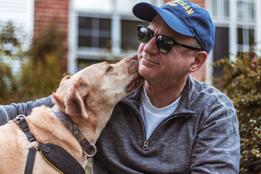 dog licking man's neck