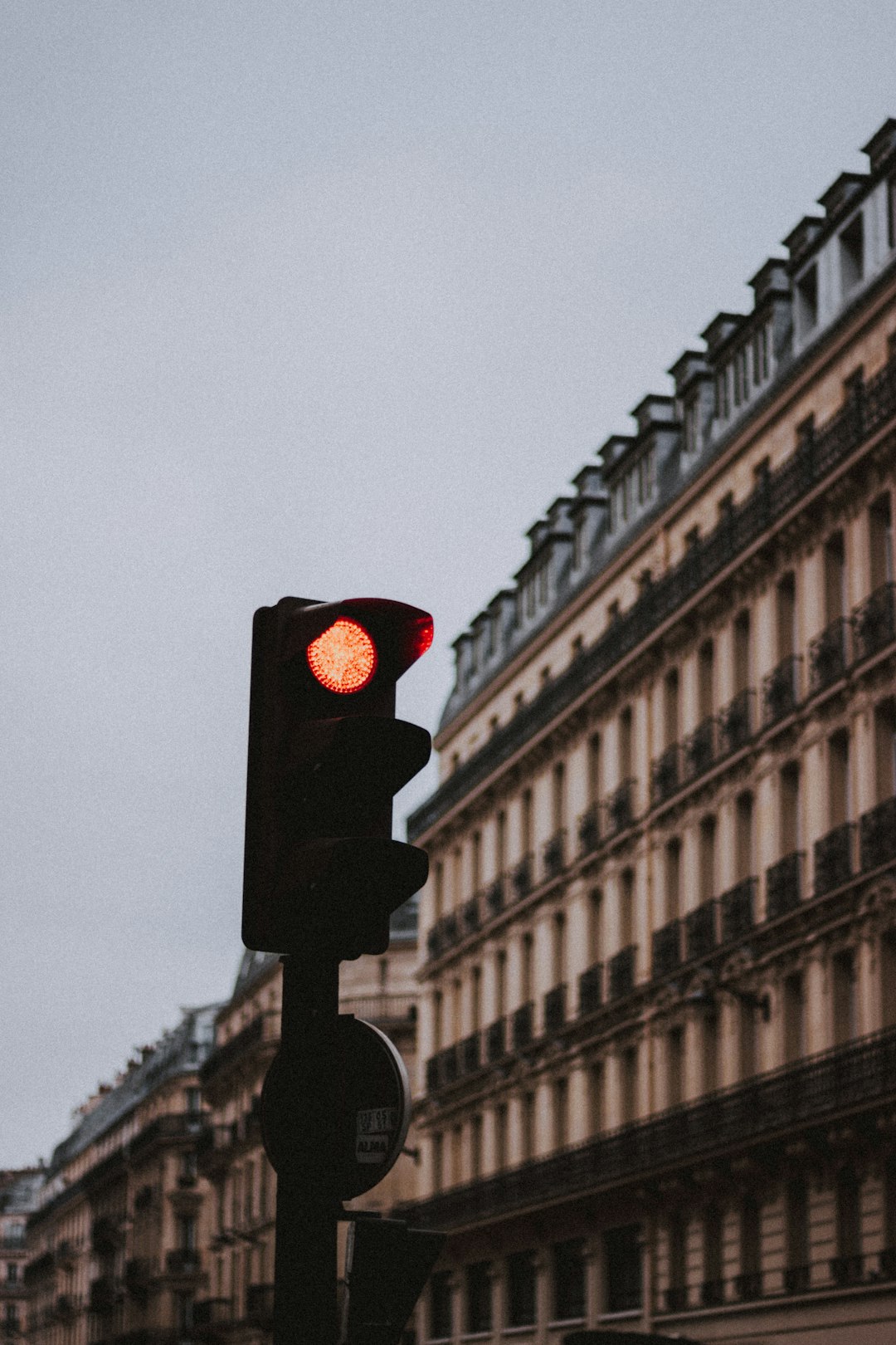 red traffic light beside building