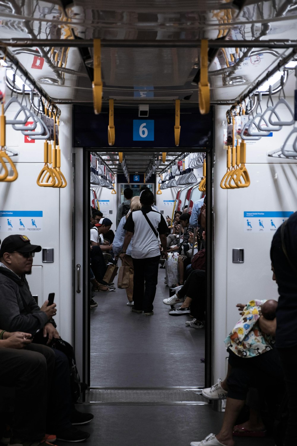 a group of people riding on a subway train