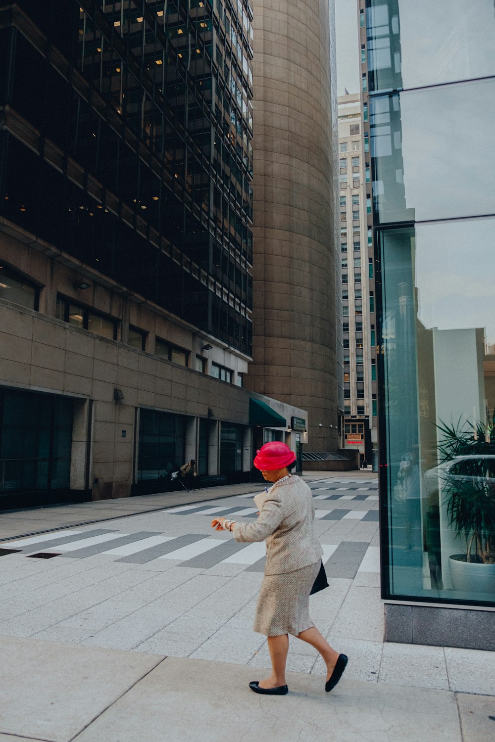 woman wearing brown formal dress crossing street