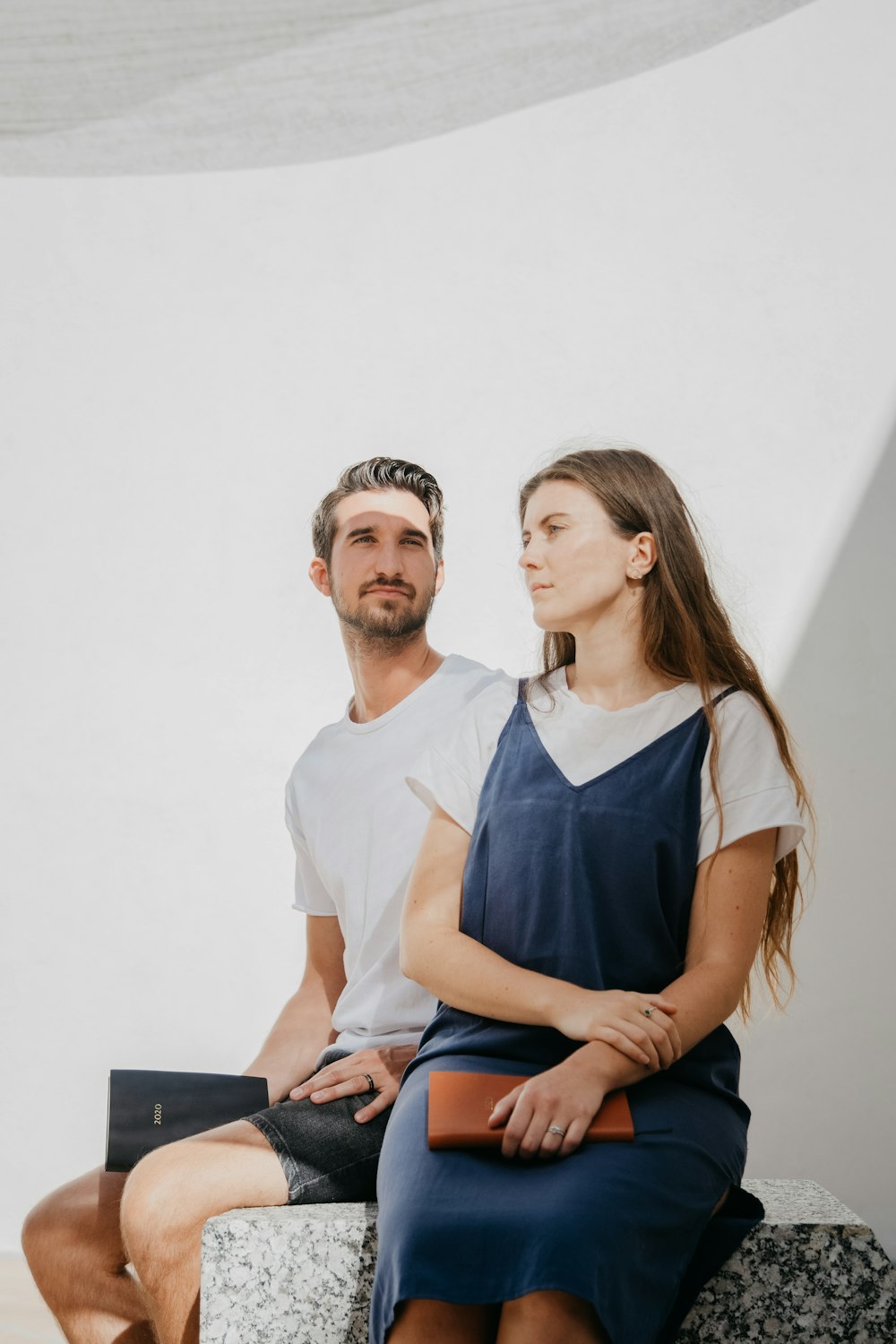 man sitting beside woman