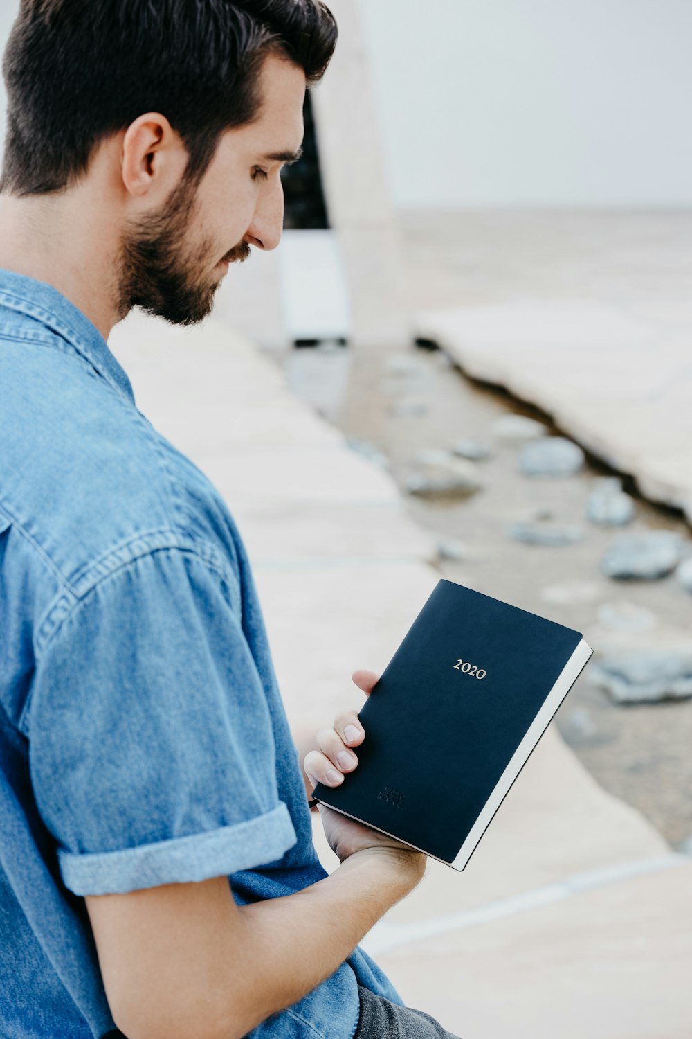 man looking and holding book