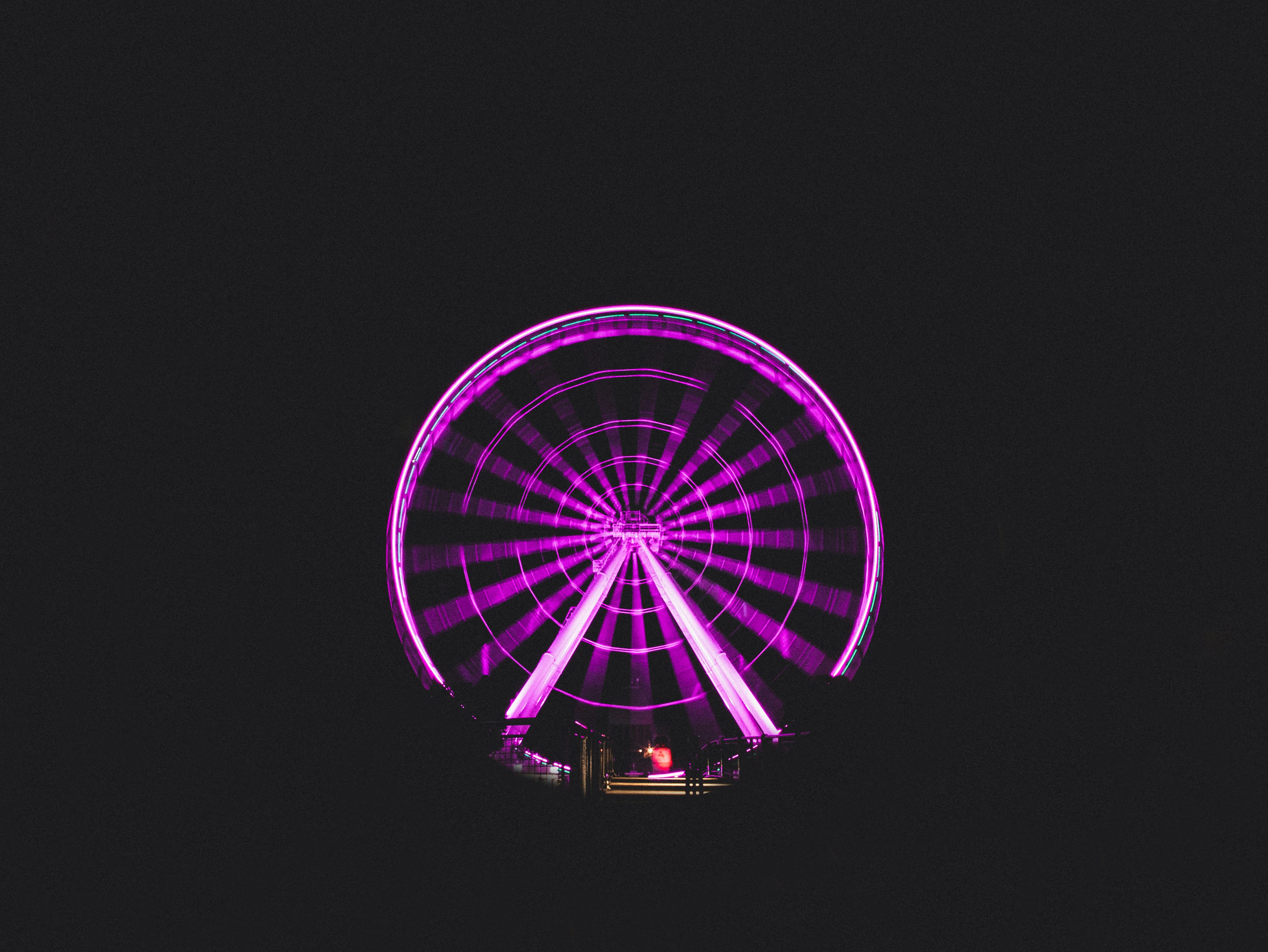 Ferris wheel with purple lights during nighttime