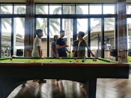 A lively game of bilardo in progress with friends enjoying their time.