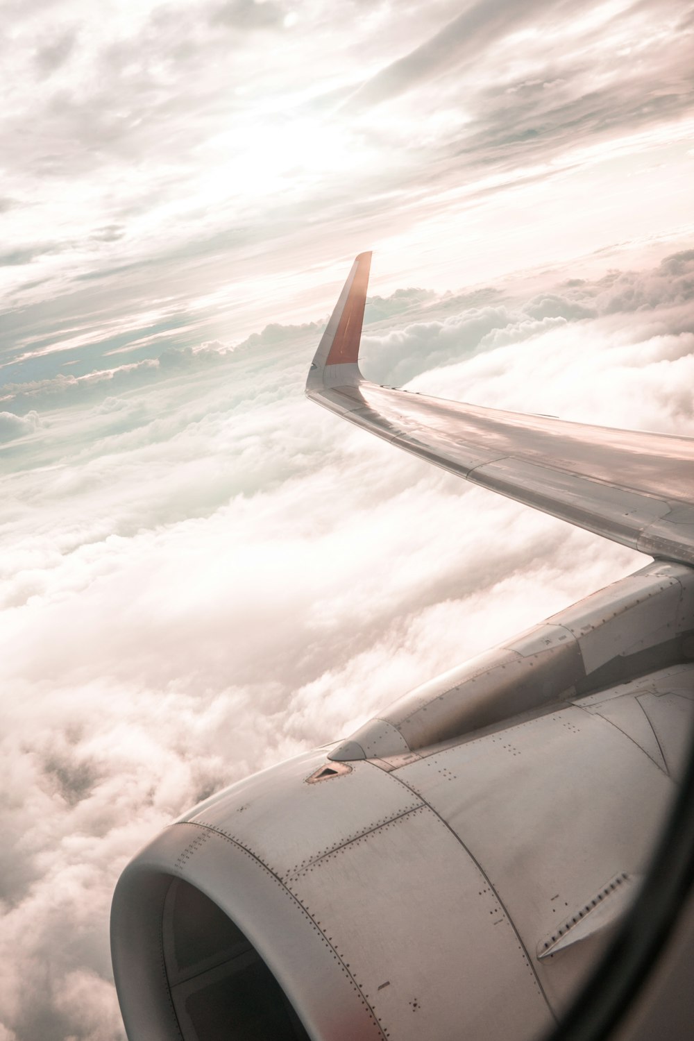 airplane wing across clouds