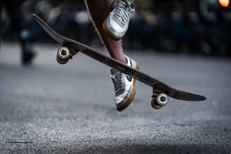 Close-up of professional skate shoes gripping the board mid-air during a trick.