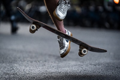 A close-up of a skateboarder performing a kickflip.