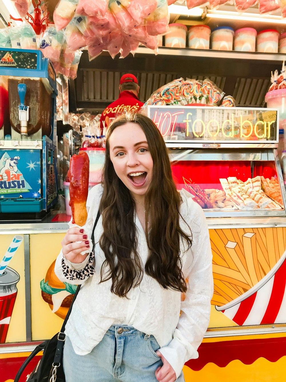 woman in white cardigan near food bar