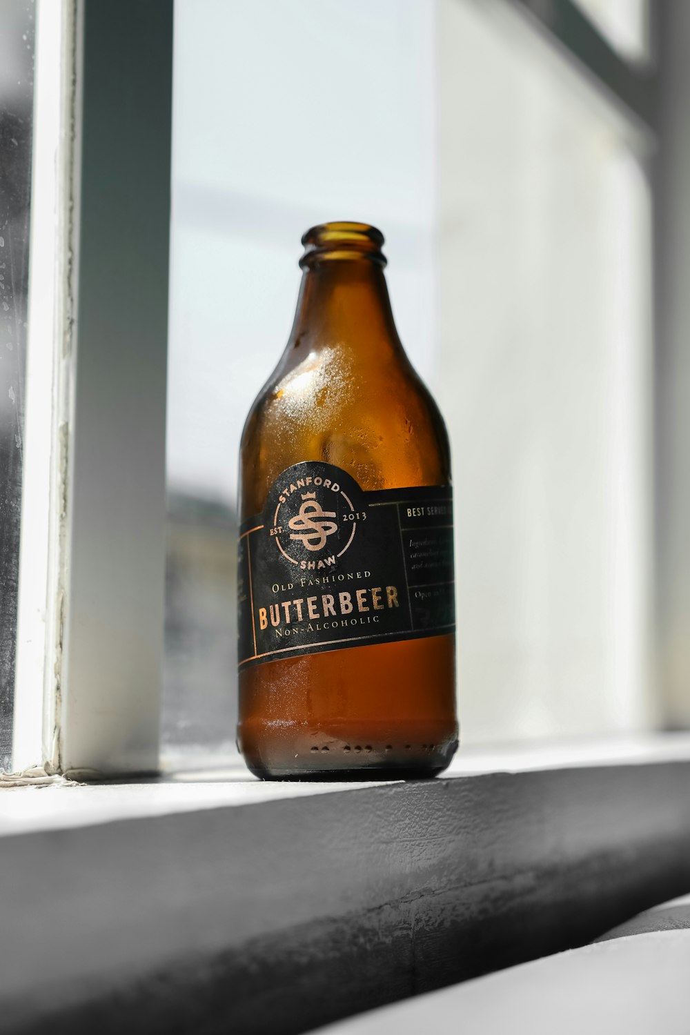Butterbeer beer bottle on window sill