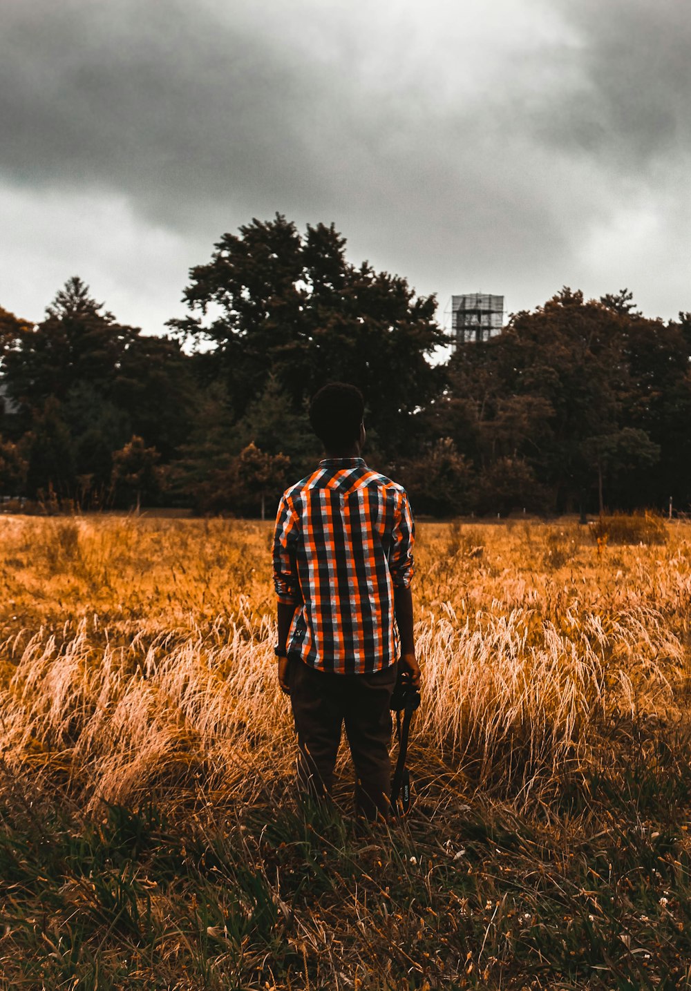 man standing on brown field