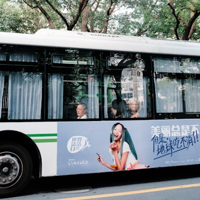 Smiling driver helping passengers board a modern, eco-friendly bus in a Chilean city.