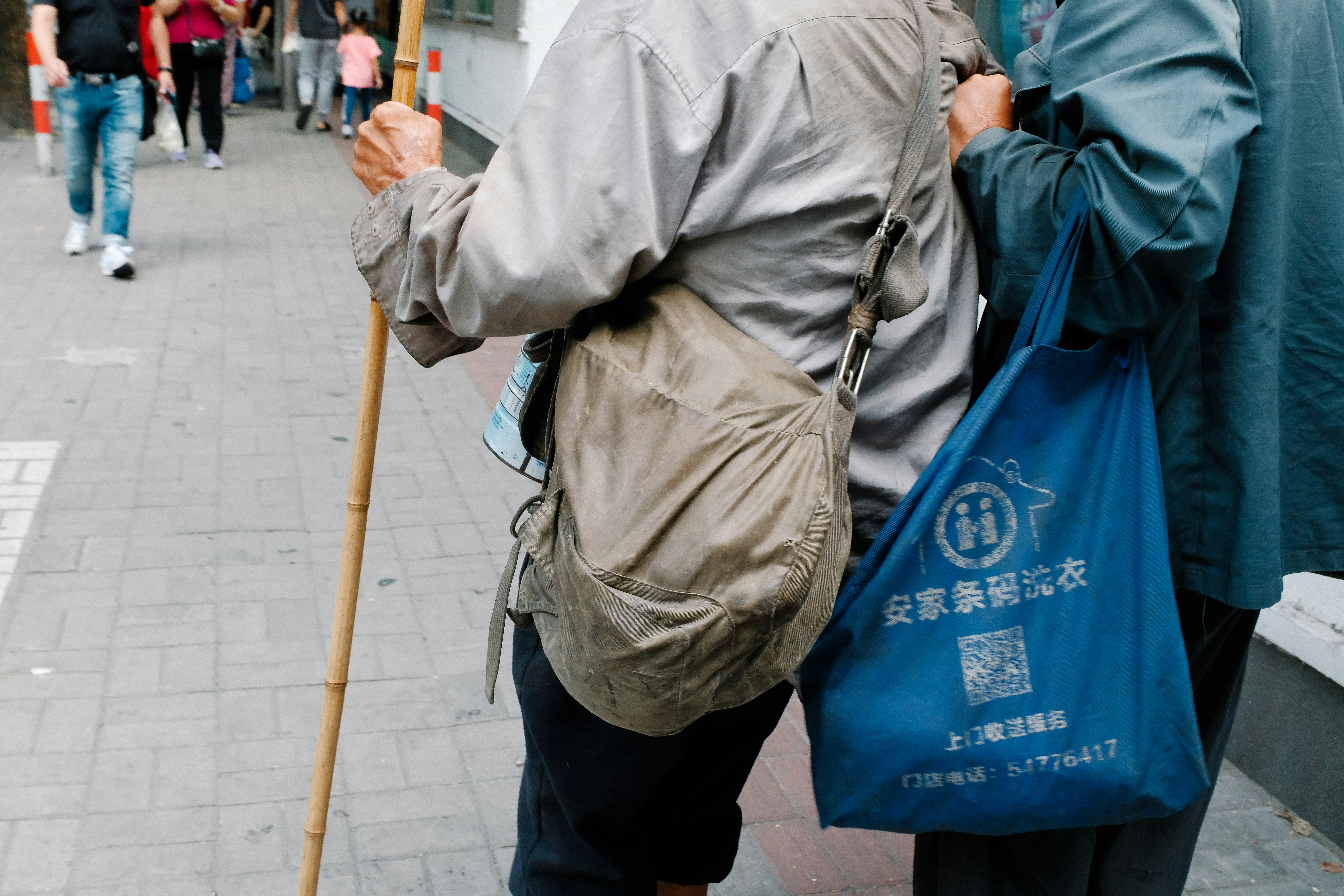 a couple of people walking down a street