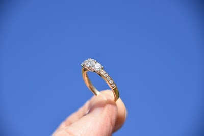 person holding gold-colored ring ring zoom background