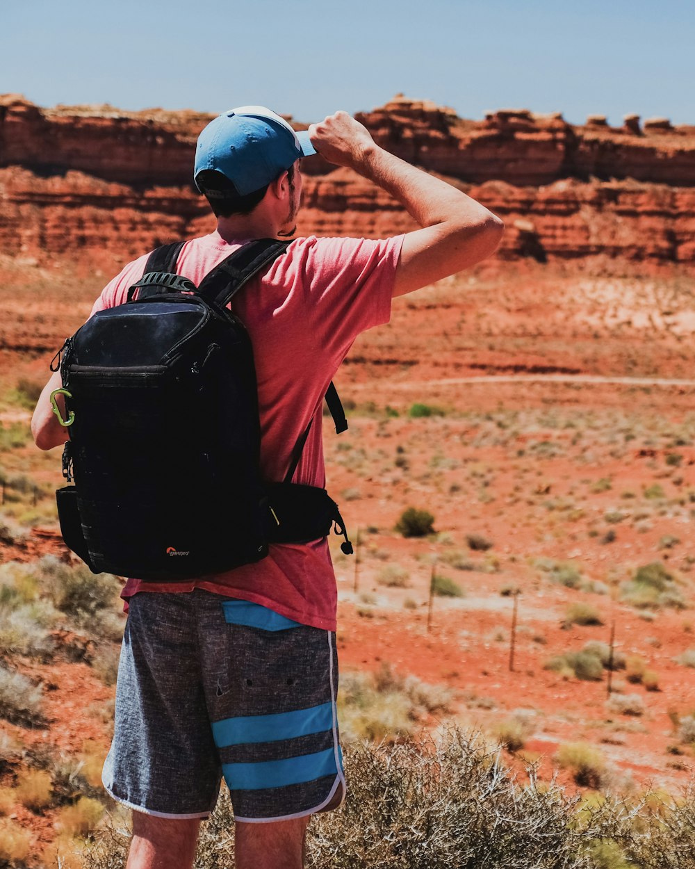 man carrying black backpack