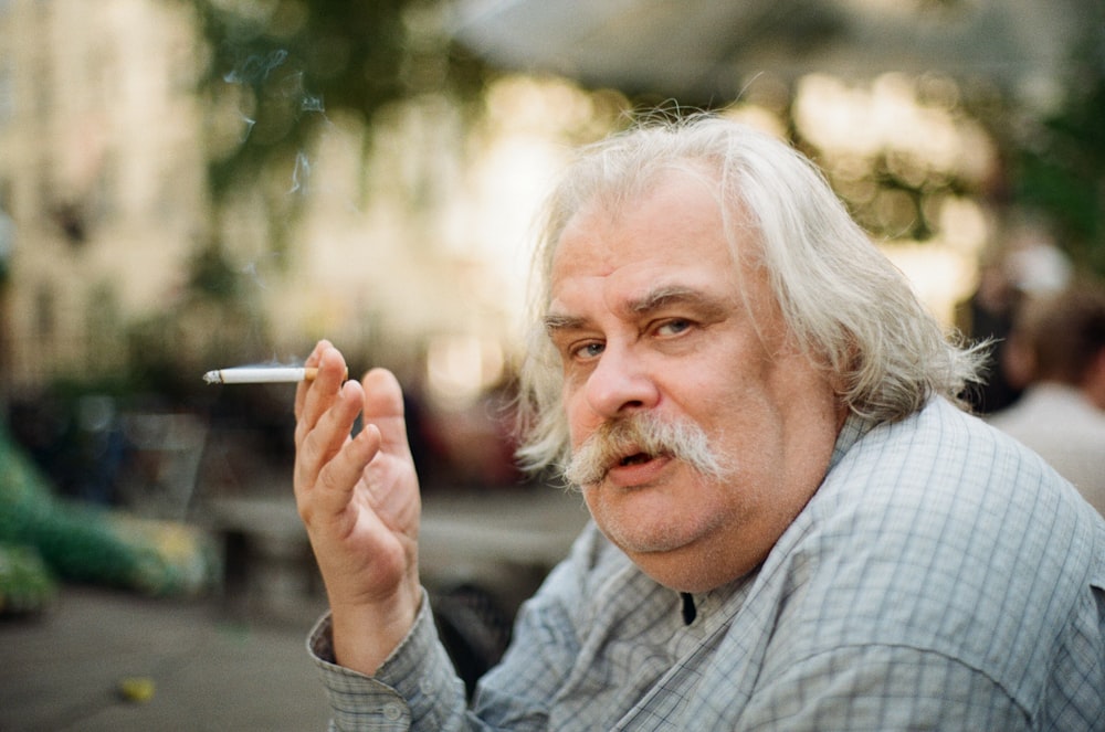 man sitting and smoking during daytime