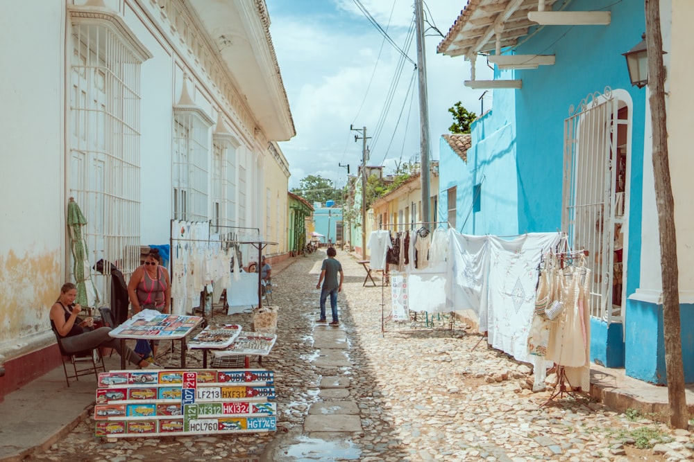 man standing on alley near houses