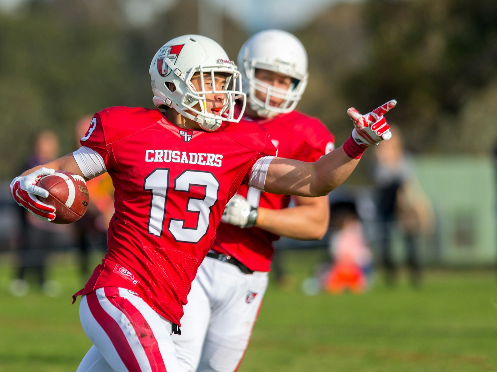 A football player celebrating after reaching the end zone