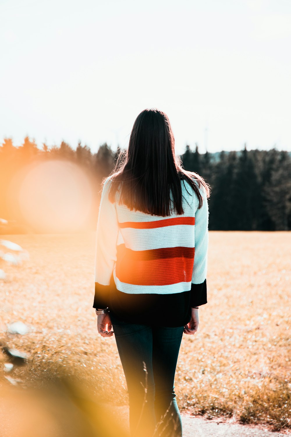 woman wearing white and orange striped sweater