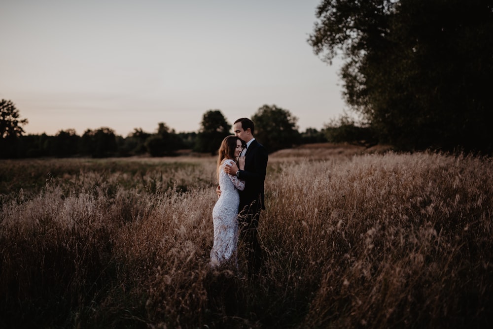 man and woman standing on grass