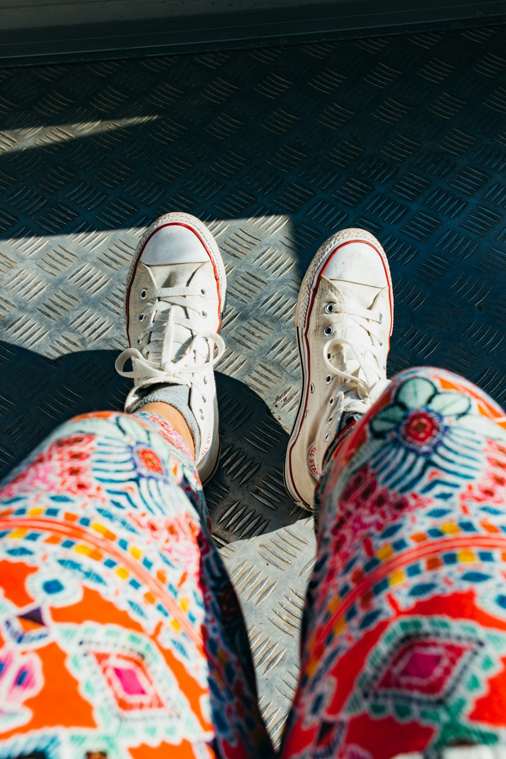 person wearing orange, teal, and red leggings