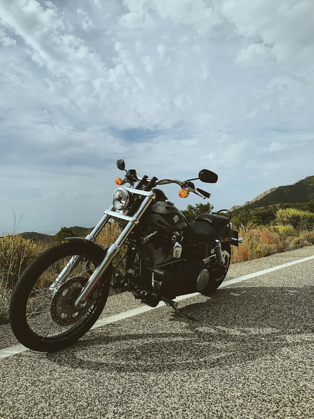 black cruiser motorcycle on road